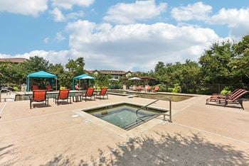 The reserve at the falls pool and hot tub with chairs and umbrellas